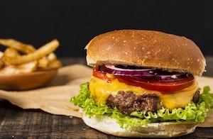 A hand crafted cheeseburger with fries