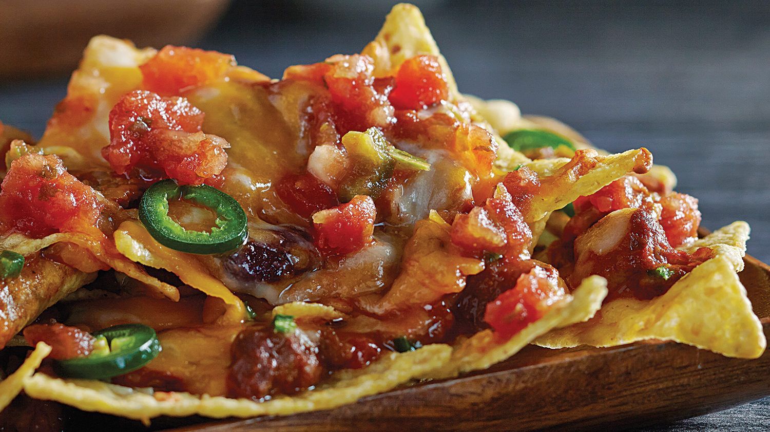 Loaded nachos with cheese, tomato and jalapenos